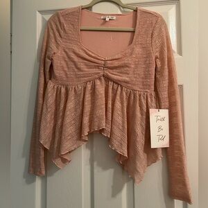 Elegant Pink baby doll styled top with a ruffled asymmetrical hem
